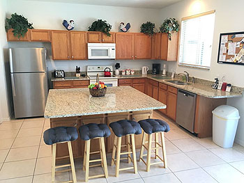 A fully equipped kitchen with granite countertops.