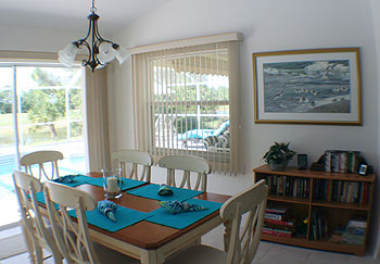 The dining space looks out over the pool too.